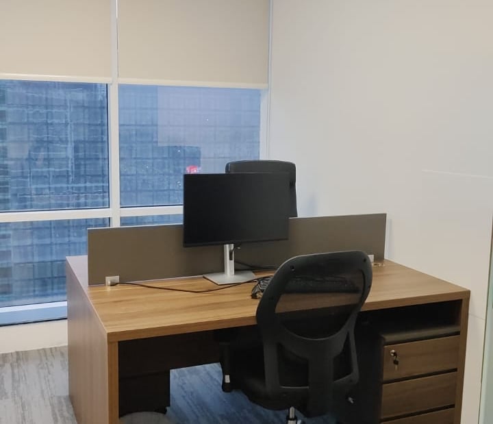 a desk with a computer and a laptop