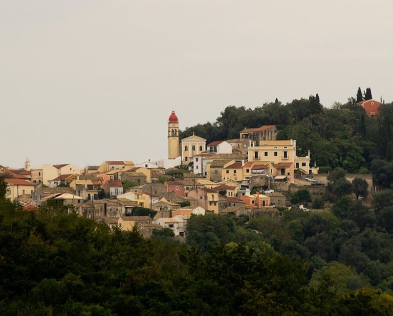 a hill with a church and a clock tower