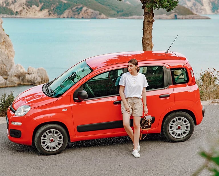 a woman standing next to a red van