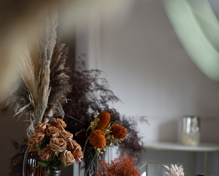 a table with a vase of flowers and a rooster, wedding