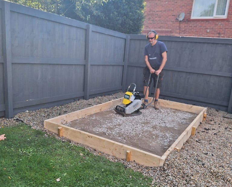 a man operating a compactor plate