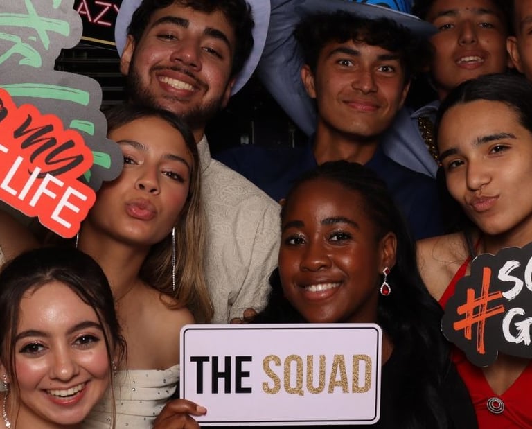 Group of teenagers posing for a photobooth photograph
