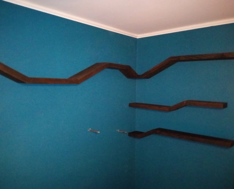 Four floating shelves mounted on wall