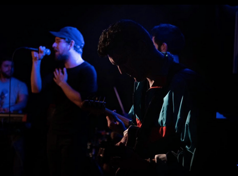 ardent ardent32m and a man playing guitar in a dark room