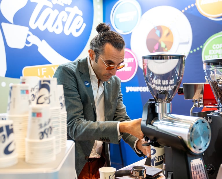 Matteo grinding coffee during Host Milan 2023