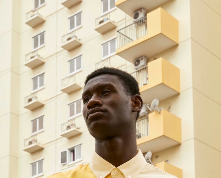 a man in a yellow shirt and black pants