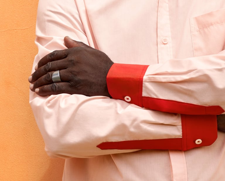a man in a white shirt and red tie dye