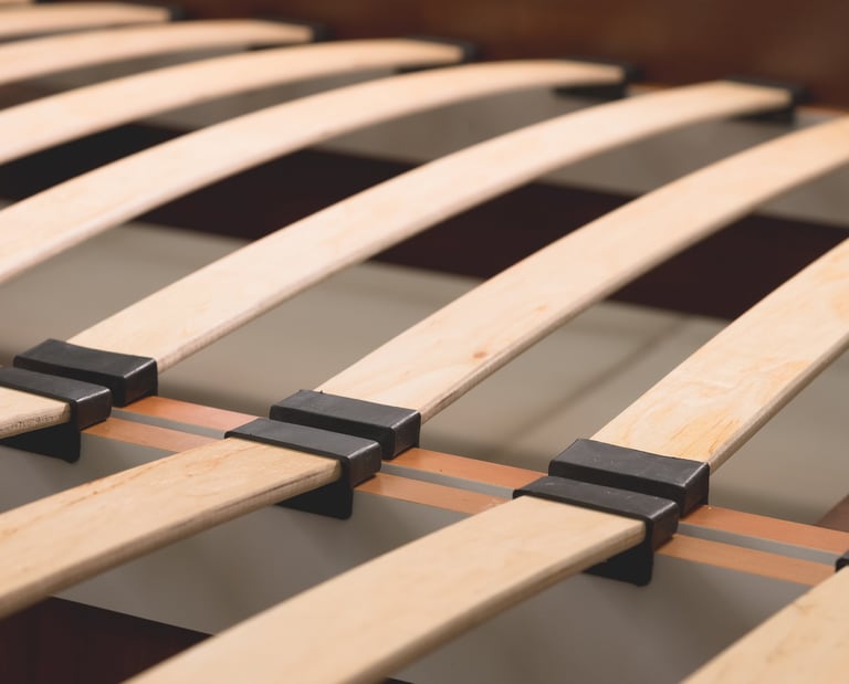  flexible wooden bed slats with black plastic holders for ergonomic mattress support.