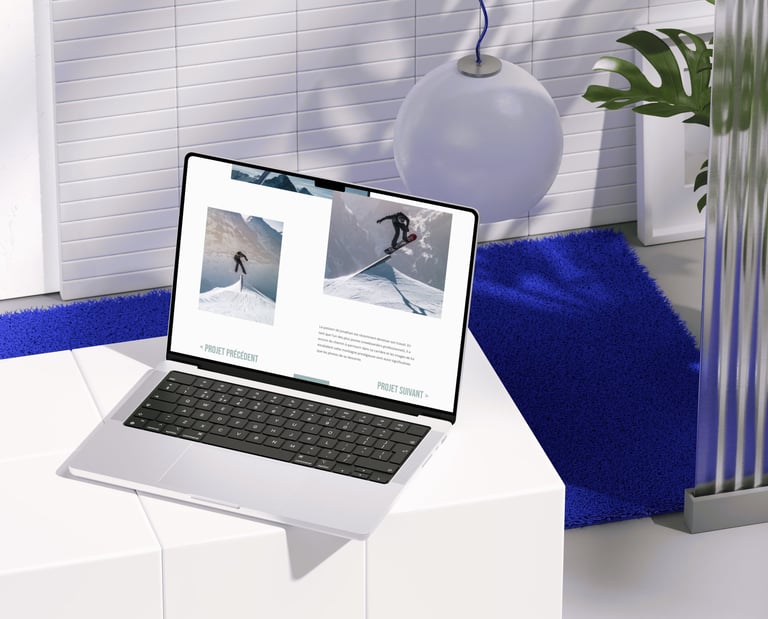 A modern laptop mockup displaying a portfolio website in a minimalist home office with blue accents.