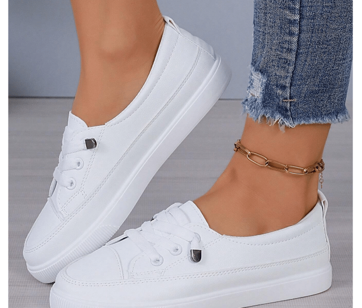 White lace-up fashion sneakers styled with maternity overalls.