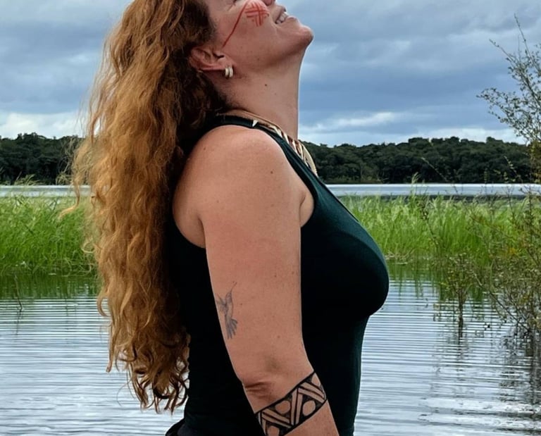 a woman with a tattoo on her arm and a tattoo on her arm