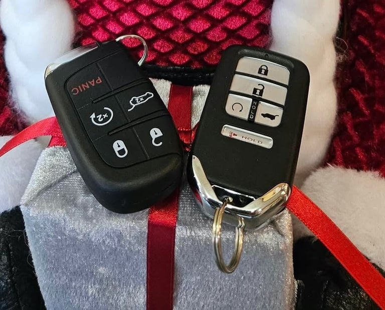 Two Honda key fobs placed on a Christmas-themed background