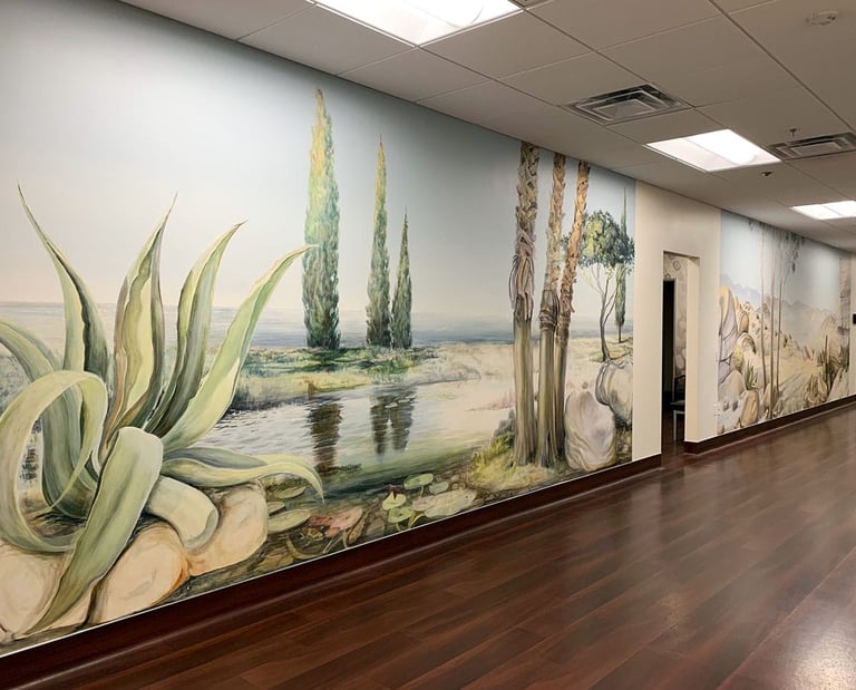 Two large panoramic murals in a clinic hallway depicting Southern Californian landscapes.