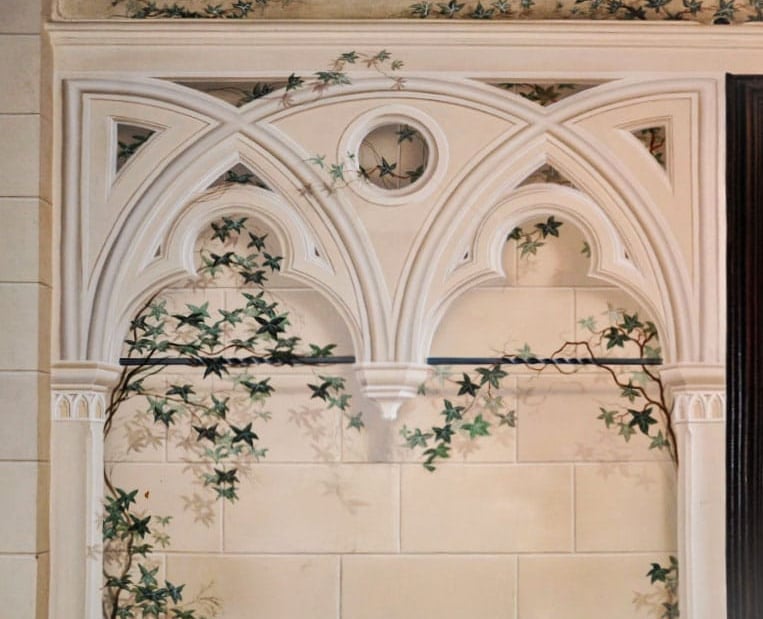 Painted trompe l'oeil gothic arch in a sandstone finish, complete with sandstone blocks in the background and ivy vines.