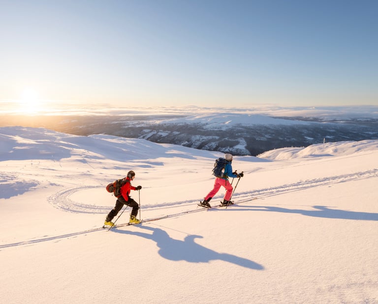 two people ski touring in the snow