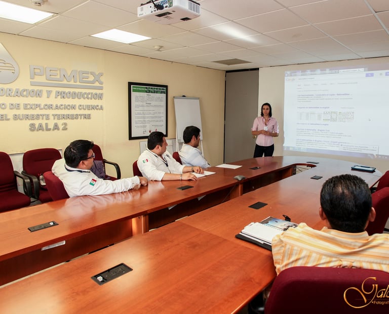 a group of people sitting at a table with a presentation