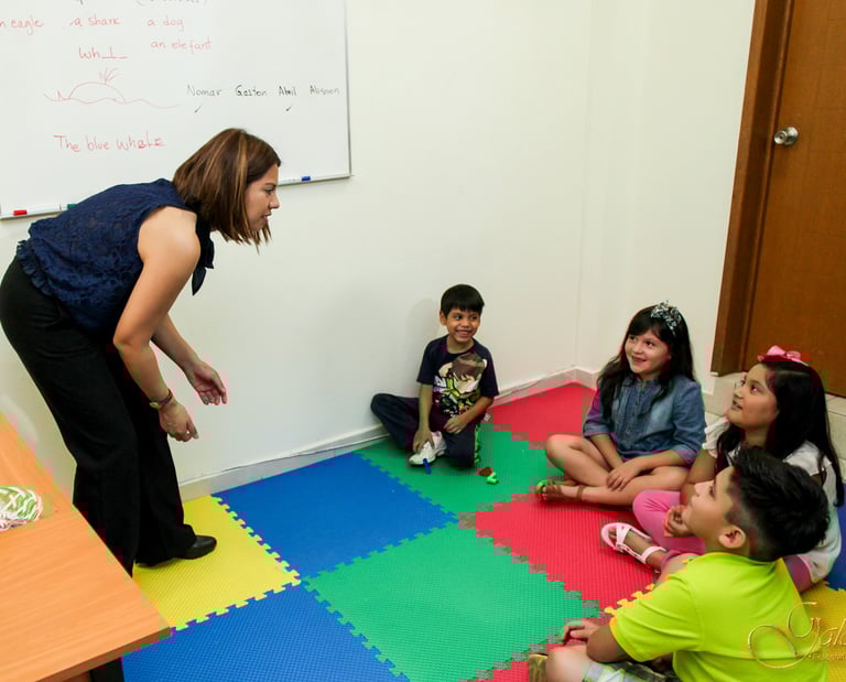 a woman standing in front of a group of children
