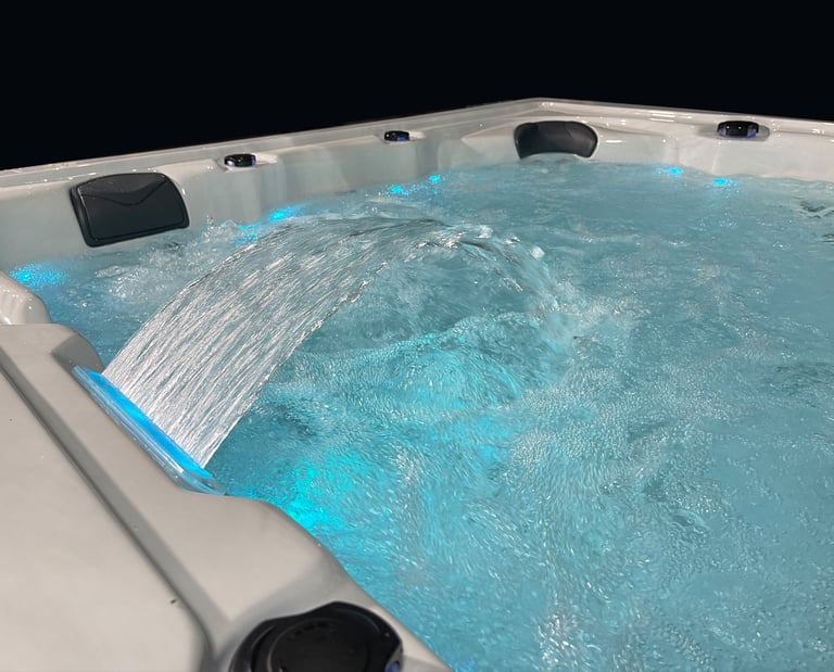 a hot tub with a waterfall flowing down the side