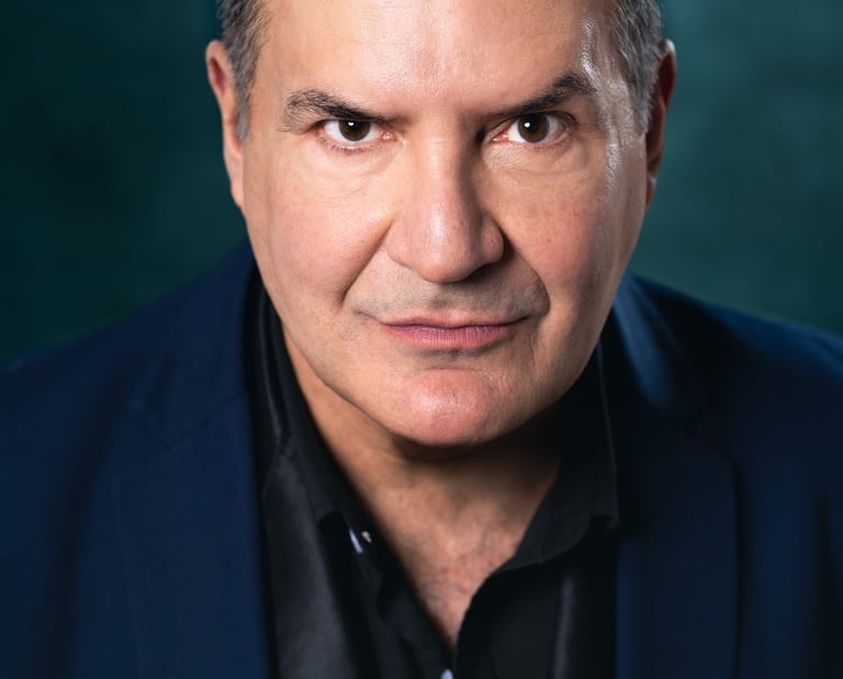 a man in a suit and tie with a black shirt