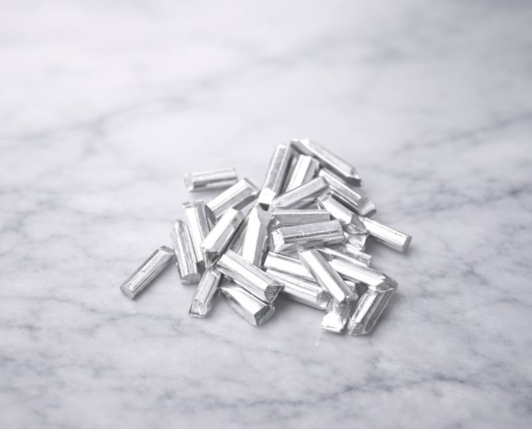 Pure silver DIY components laid out on marble for jewelry making and crafting