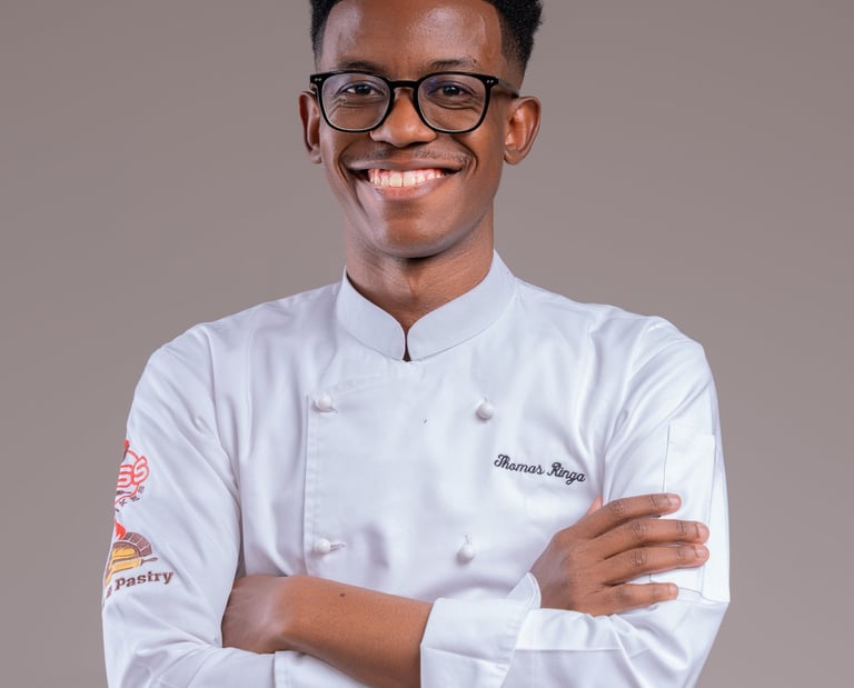a man in a chef's uniform and glasses