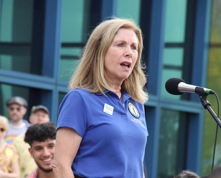 a woman in a blue shirt and a microphone