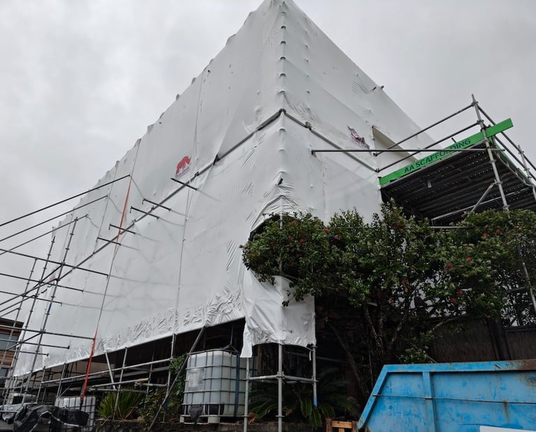 Shrink wrapped home for recladding - CHR Builders