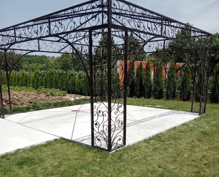 Elegant wrought iron garden gazebo with decorative scrollwork on a white patio base.