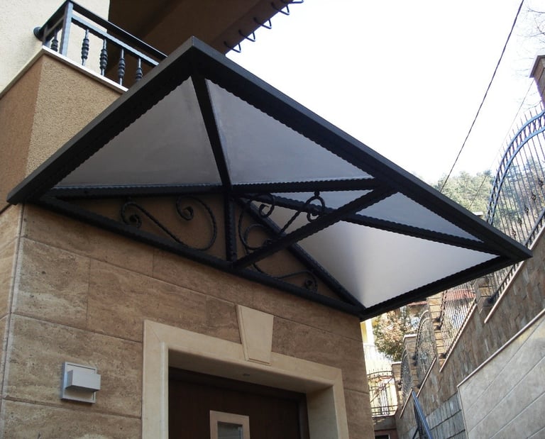 Modern floating wood staircase with ornate wrought iron railing and intricate floral scrollwork.