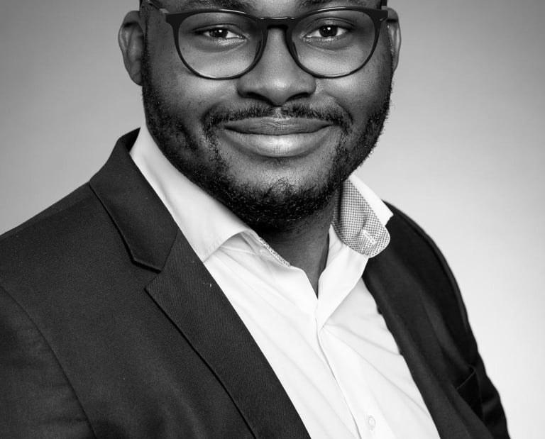 a man in a suit and glasses smiling