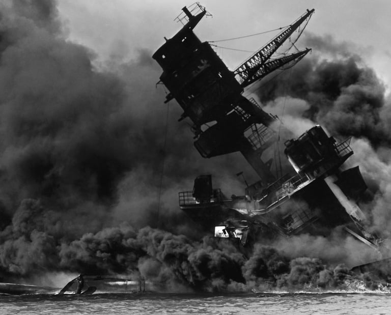 A navy ship up in smoke and sinking after being bombed at Pearl Harbor.