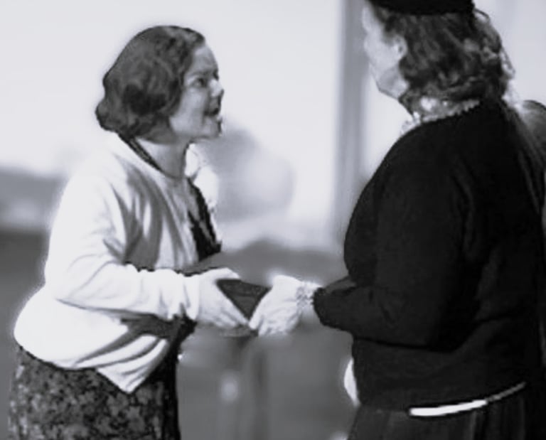 An angry Young Catherine trying to tug a box away from a woman.