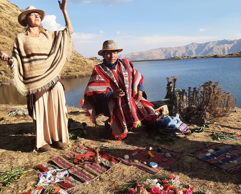 Andean shaman performing a traditional ritual with flowers by a high-altitude mountain lake.