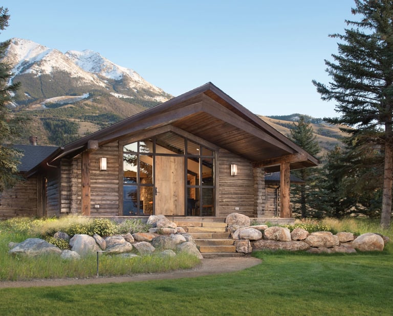 a log cabin with a mountain view of a mountain