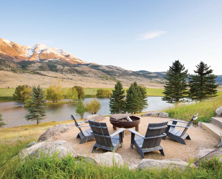 a fire pit with chairs and a fire pit