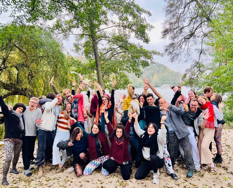 a group of people standing around a lake