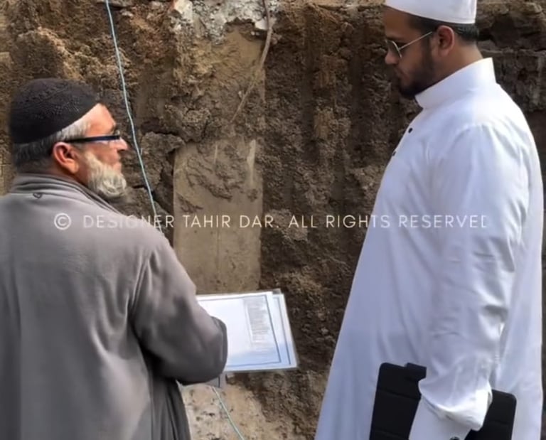 Engineer and architect in Hyderabad discussing construction plans with workers on-site, showcasing t