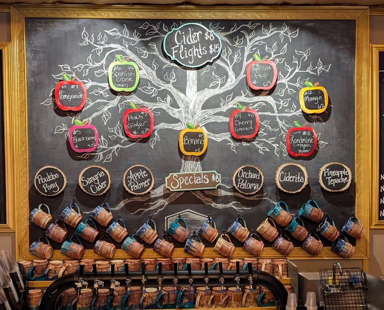 Chalkboard menu at a cider house bar featuring cider flights, wine, beer, and non-alcoholic drinks.