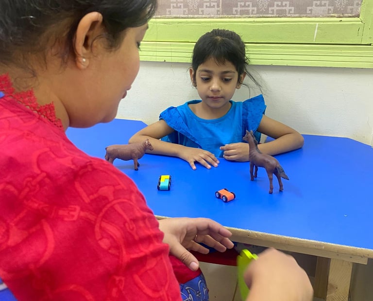 Child interacting with colorful therapy materials