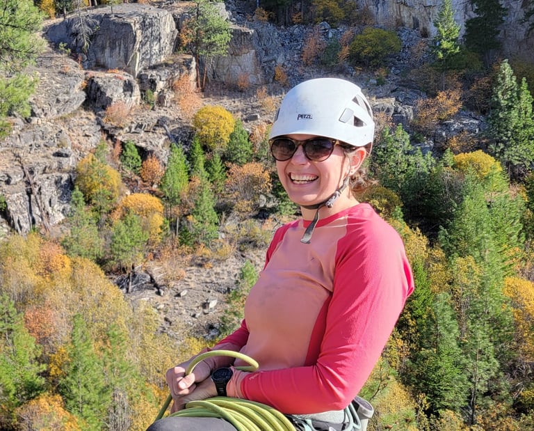 Nat smiling at the top of a climb in Skaha