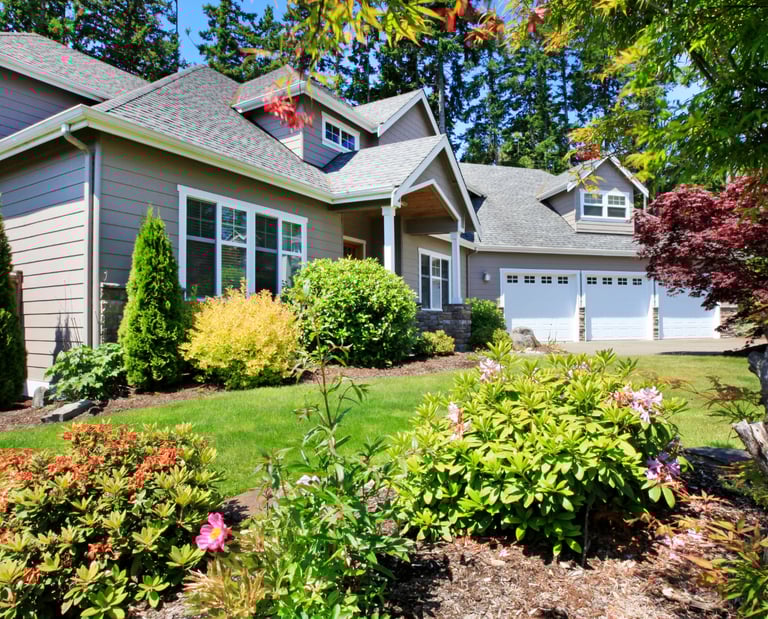 Residential landscape with layered perennials, shrubs, and a well-kept WNY garden.