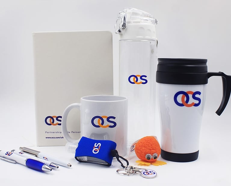 OCS corporate merchandise kit with branded drinkware, mug, notebook and office accessories