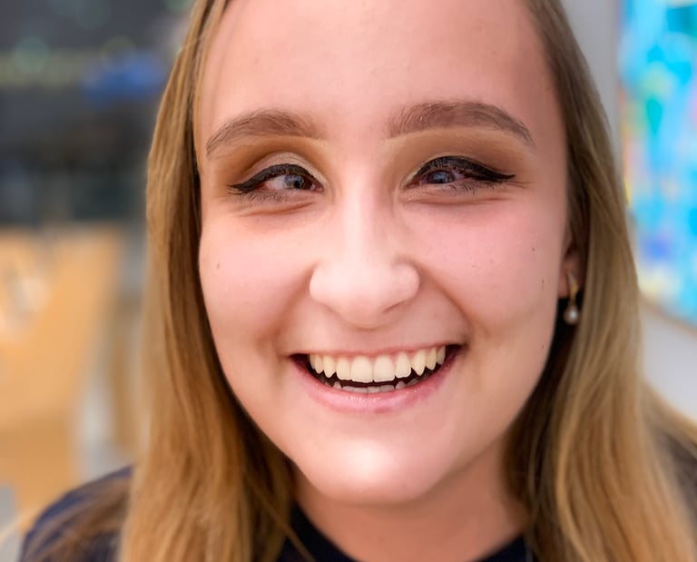 A blond-haired woman founder Zhenya Pankova, smiles at the camera.