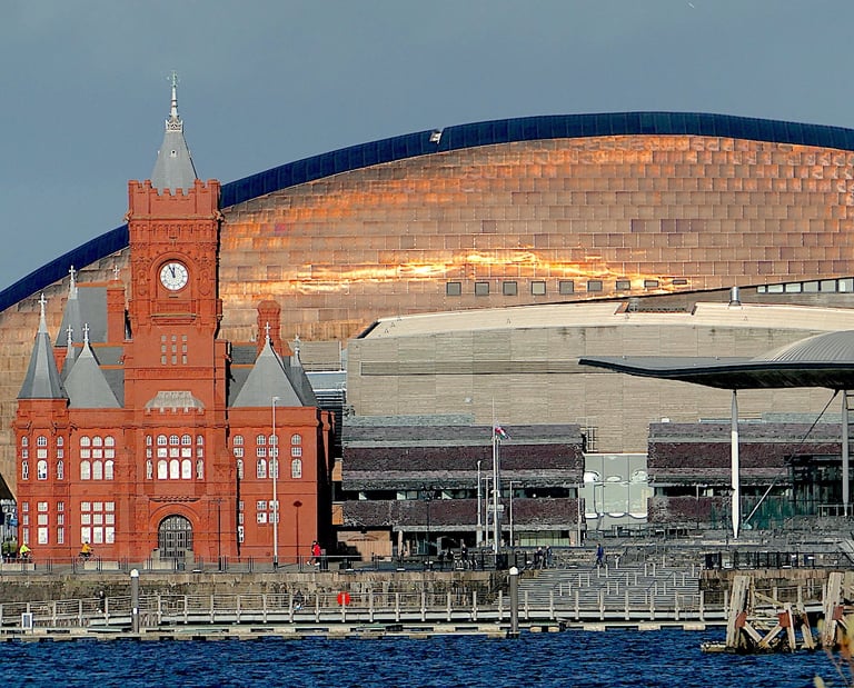 The Pierhead Building and Wales Millennium Centre in Cardiff Bay at sunset.