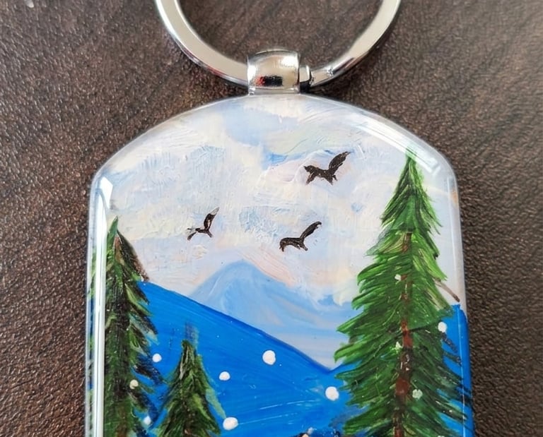 Carry the timeless majesty of the high mountains wherever you go with this original, hand-painted wo
