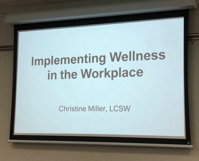 A warm group of diverse adults seated in a cozy circle during a lively therapy workshop.