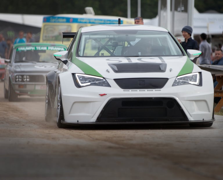 Cars getting ready to assemble before dring up the track at the Goodwood Festival of Speed 2015