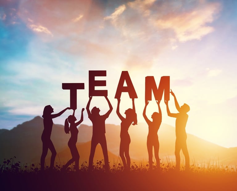 a group of people holding up a team building sign