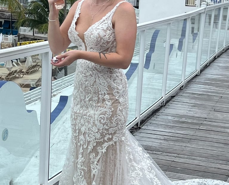 a woman in a white dress standing on a deck