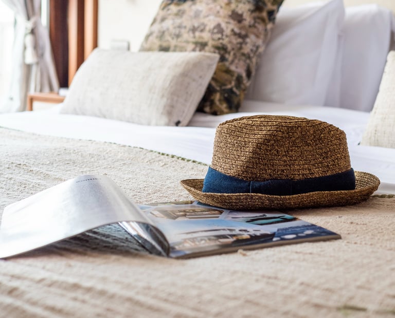 Curated luxury travel lifestyle detail with natural textures, evoking slow travel